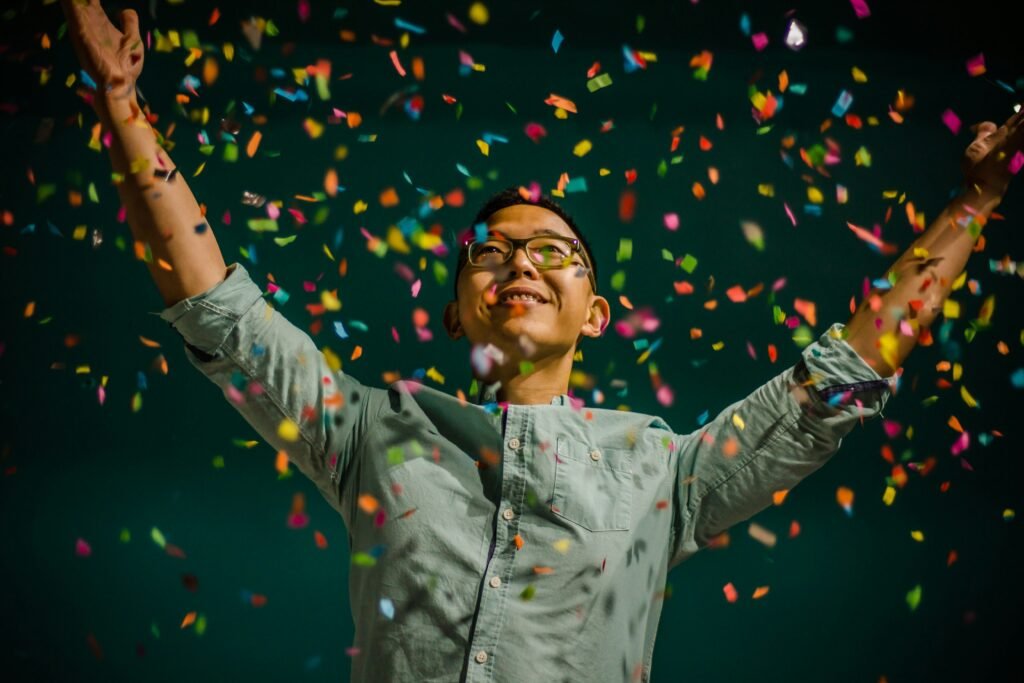 Man celebrating after winning - confetti falling