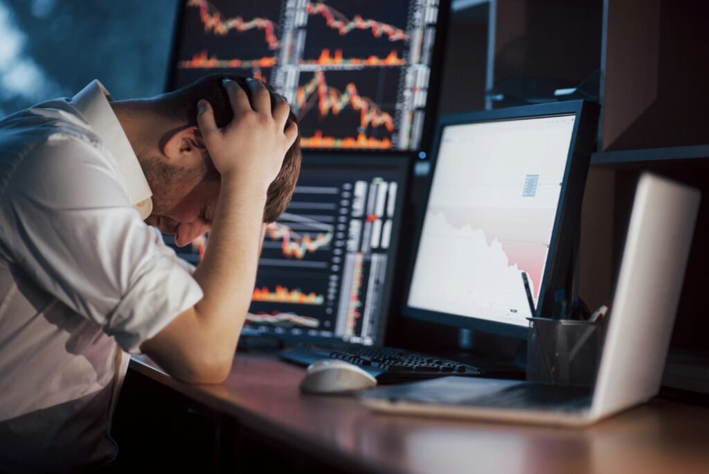 Sad man looking at trading screen