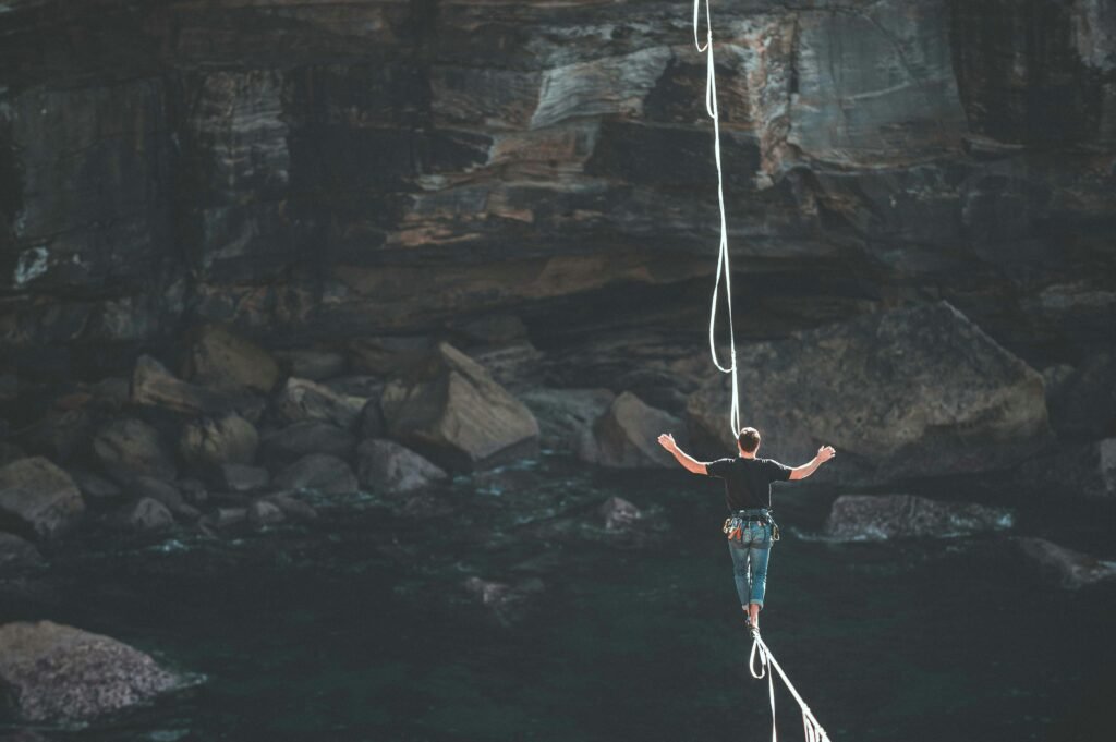 Man walking tightrope showing risk and position sizing