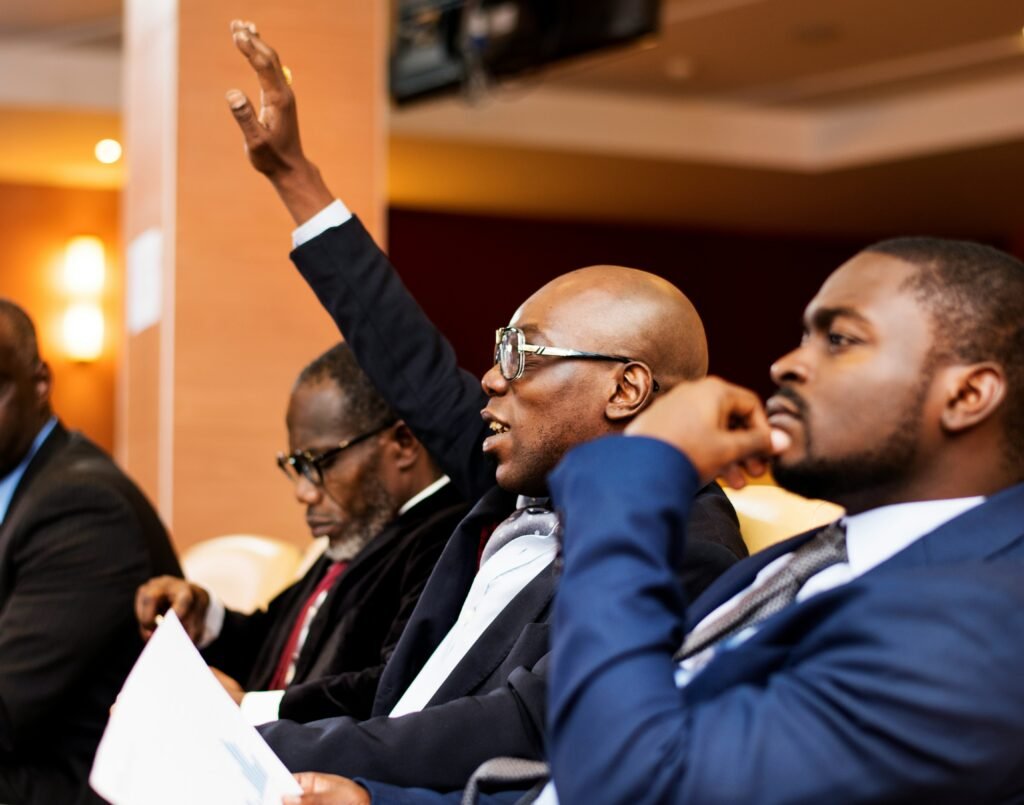 Man with hand up - asking a question